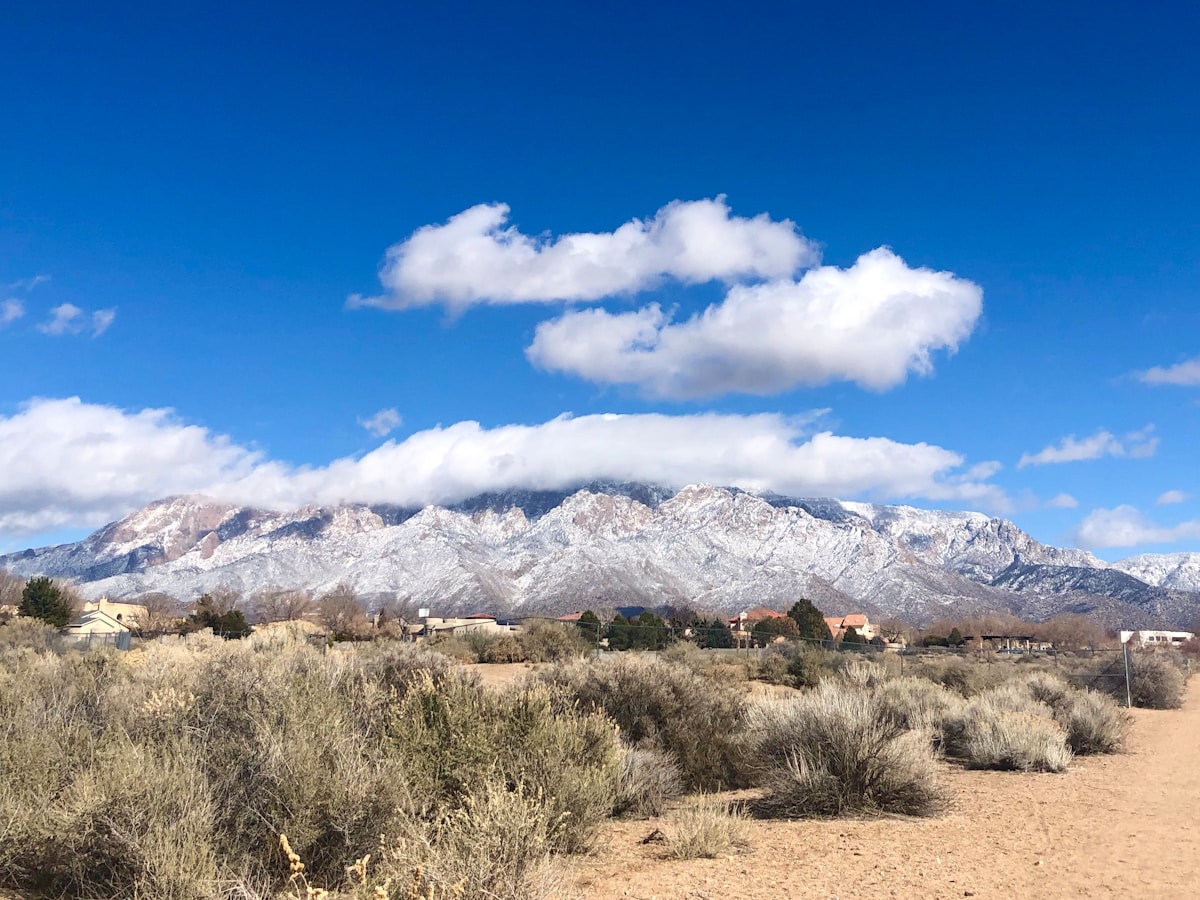 Brown and white Sandia Mountains under blue sky, near Albuquerque, New Mexico