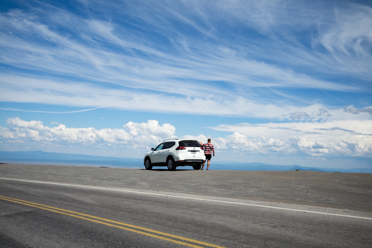 White SUV parked at a viewpoint above Crater Lake in Oregon
