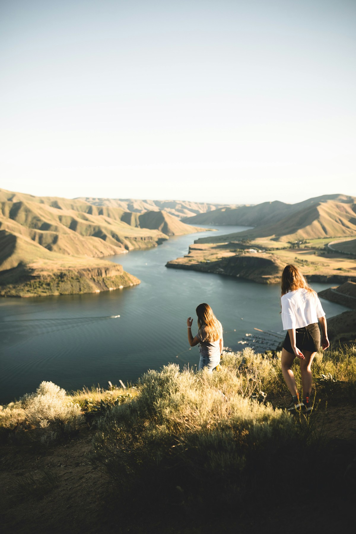 Woman standing on green grass near a lake in Boise, Idaho