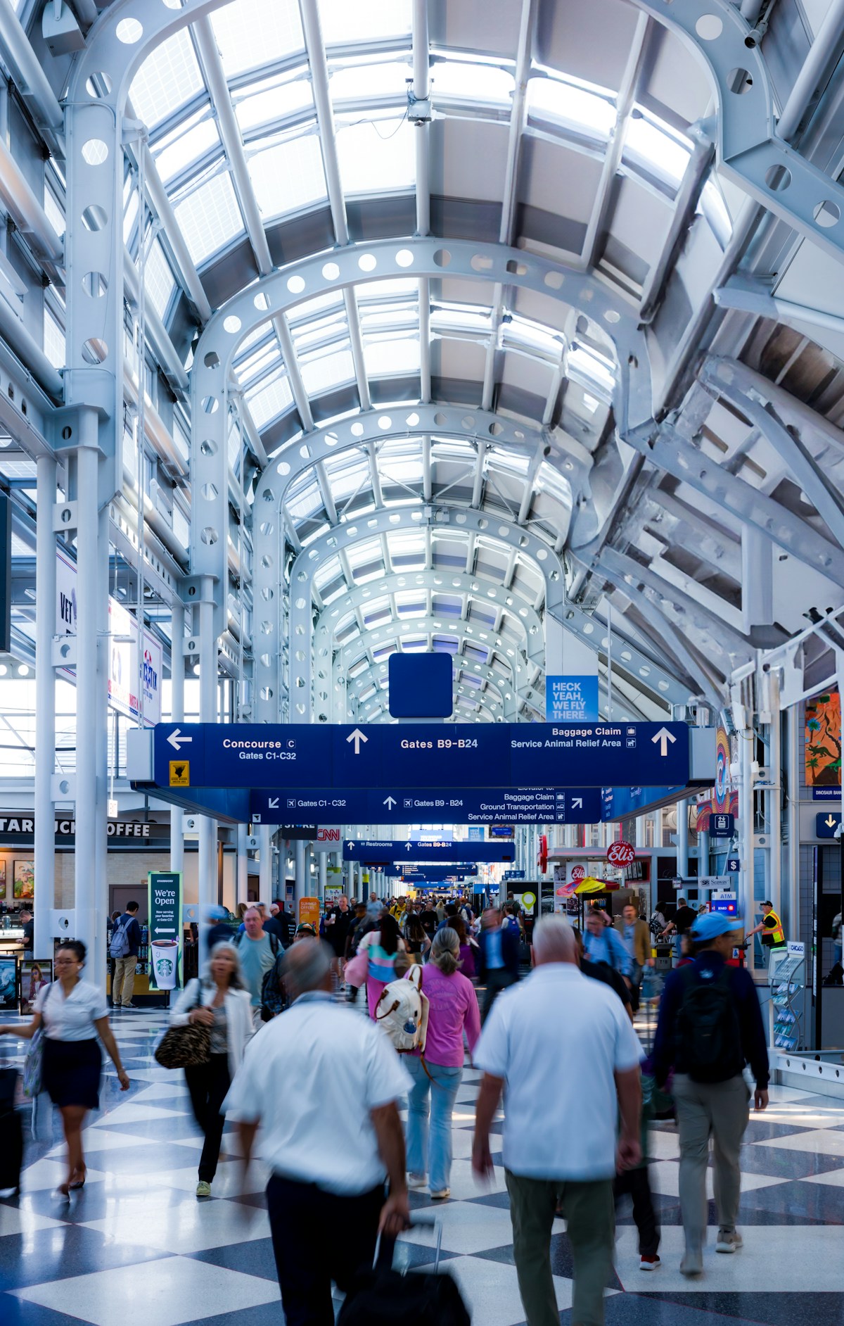 Travelers walking through the illuminated concourse at O'Hare International Airport, Chicago