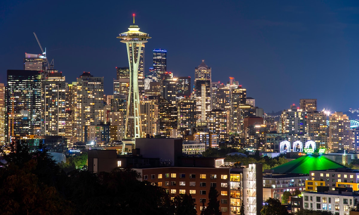 The Seattle Space Needle rising above the city with Mount Rainier visible in the background on a clear day