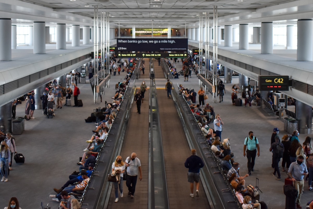 Travelers walking through Denver International Airport terminal, Colorado