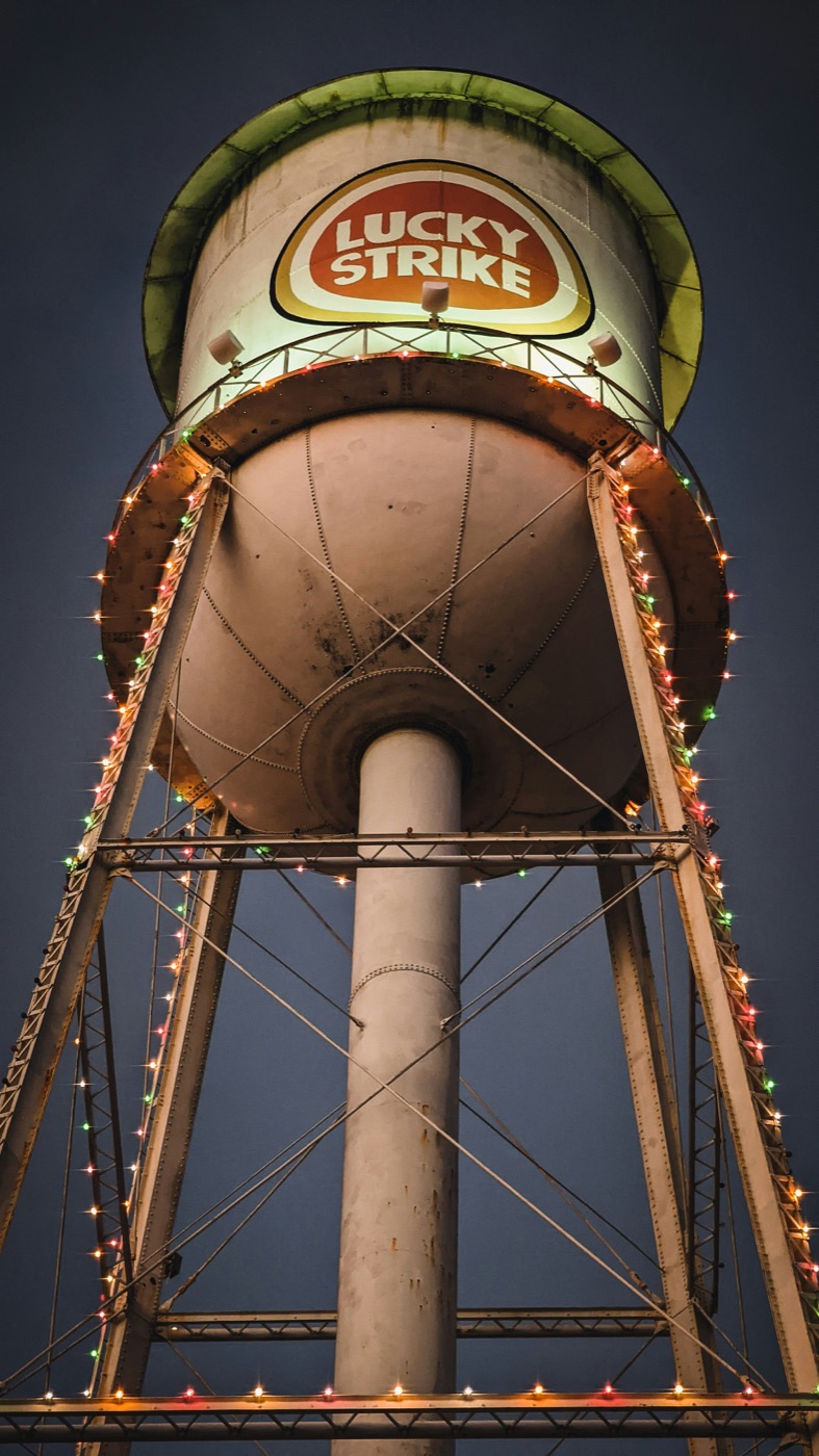 Lucky Strike water tower lit with Christmas lights at night, Durham North Carolina