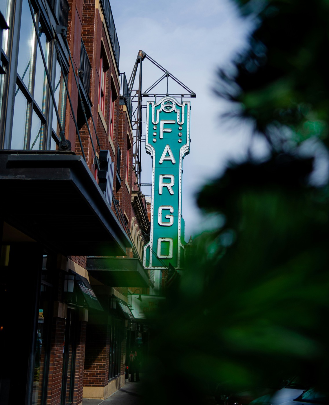 Iconic Fargo Theatre green neon sign on Broadway in downtown Fargo, North Dakota