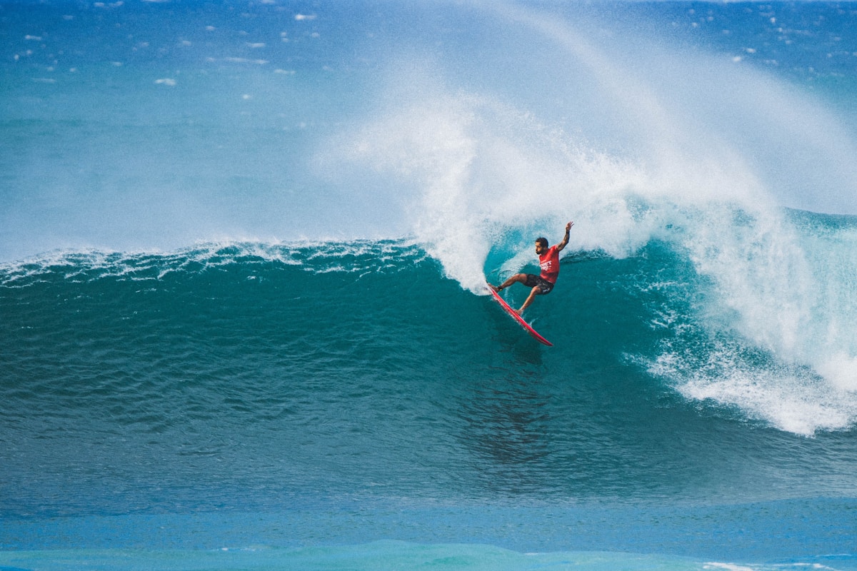 Professional surfer riding a large wave at Sunset Beach, North Shore, Oahu, Hawaii