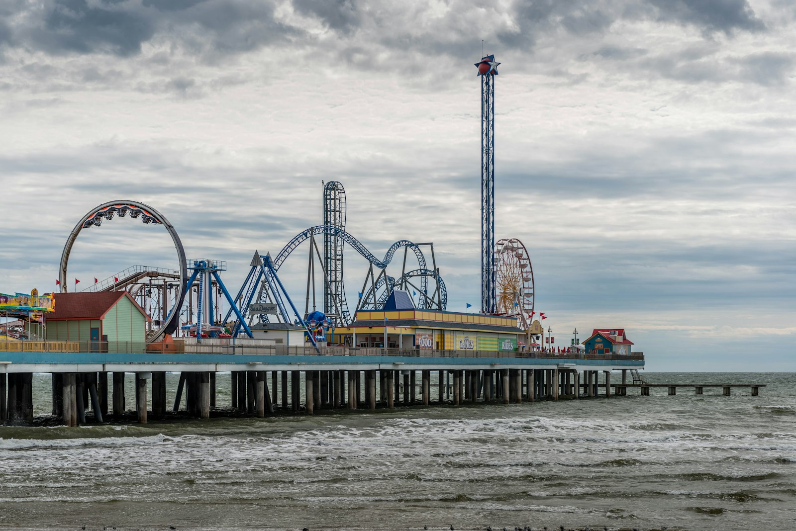 Galveston Island Pleasure Pier with roller coaster and carnival rides over the Gulf of Mexico, Texas