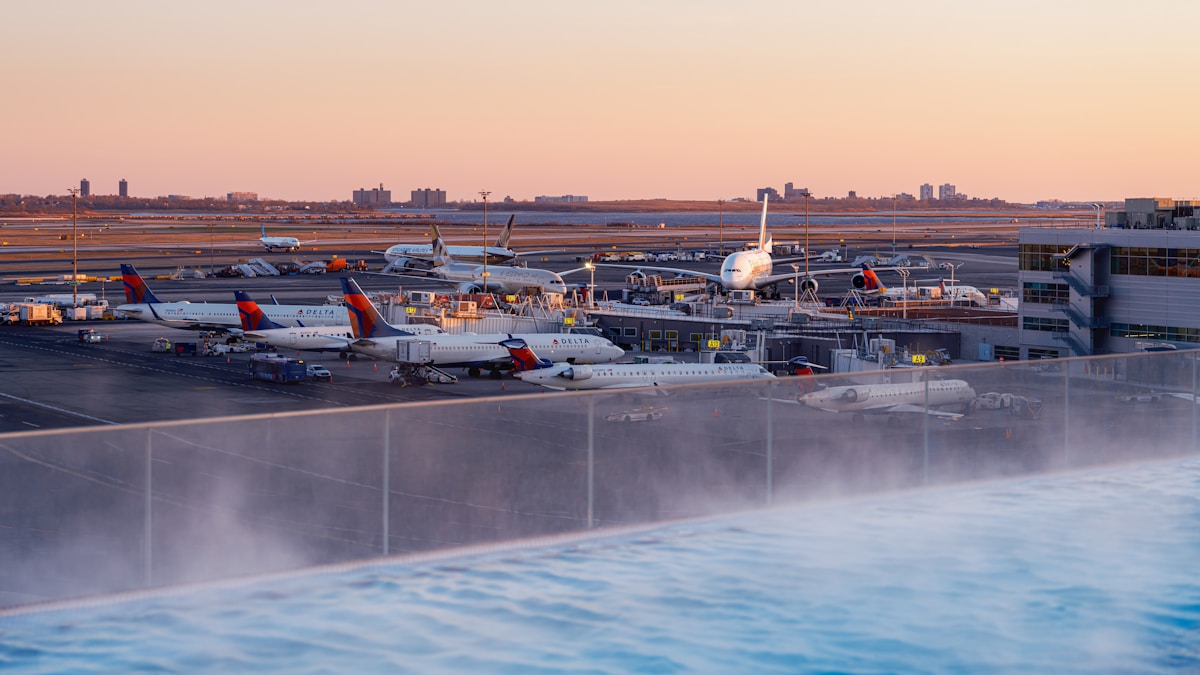 Delta aircraft parked at JFK International Airport gates at sunset, New York