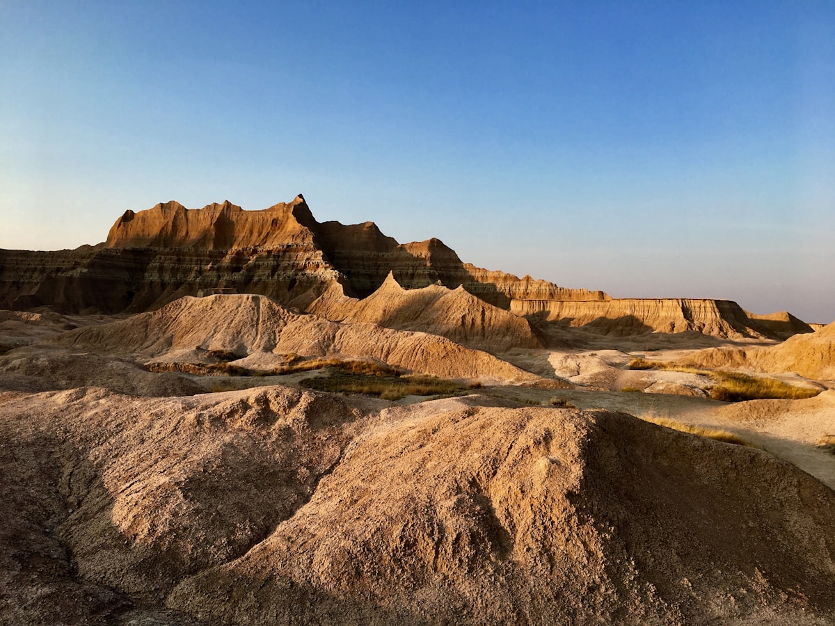Layered striped rock formations at golden hour, Badlands National Park, South Dakota