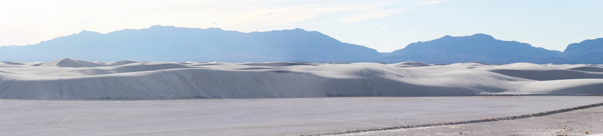 Rolling white gypsum dunes stretching to the San Andres Mountains horizon, White Sands National Park, New Mexico