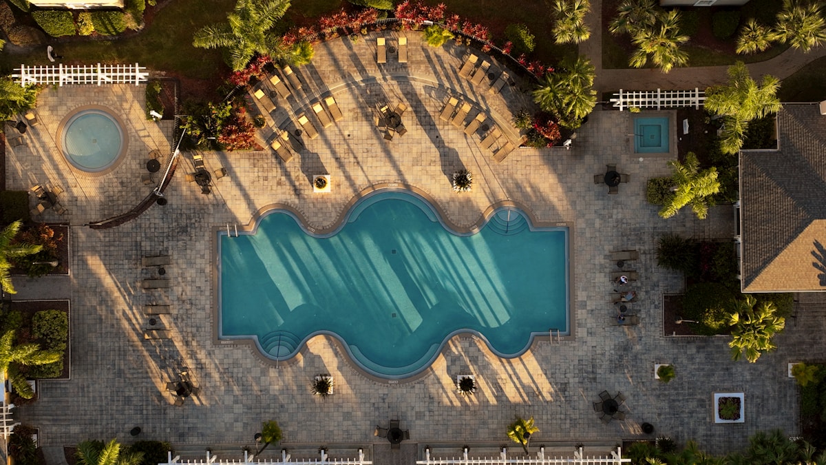 Aerial view of a resort swimming pool surrounded by palm trees in Orlando, Florida