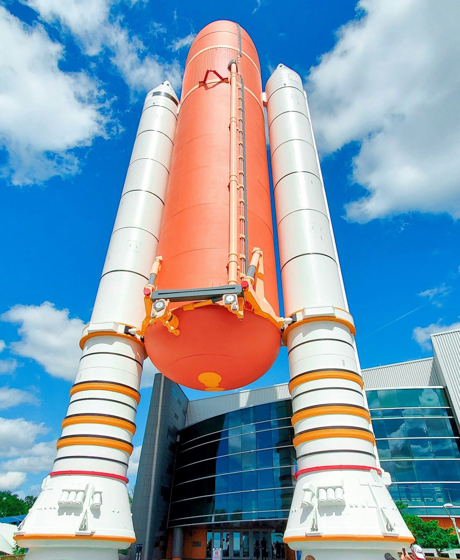 Large orange and white rocket booster on display outside Kennedy Space Center, Cape Canaveral, Florida