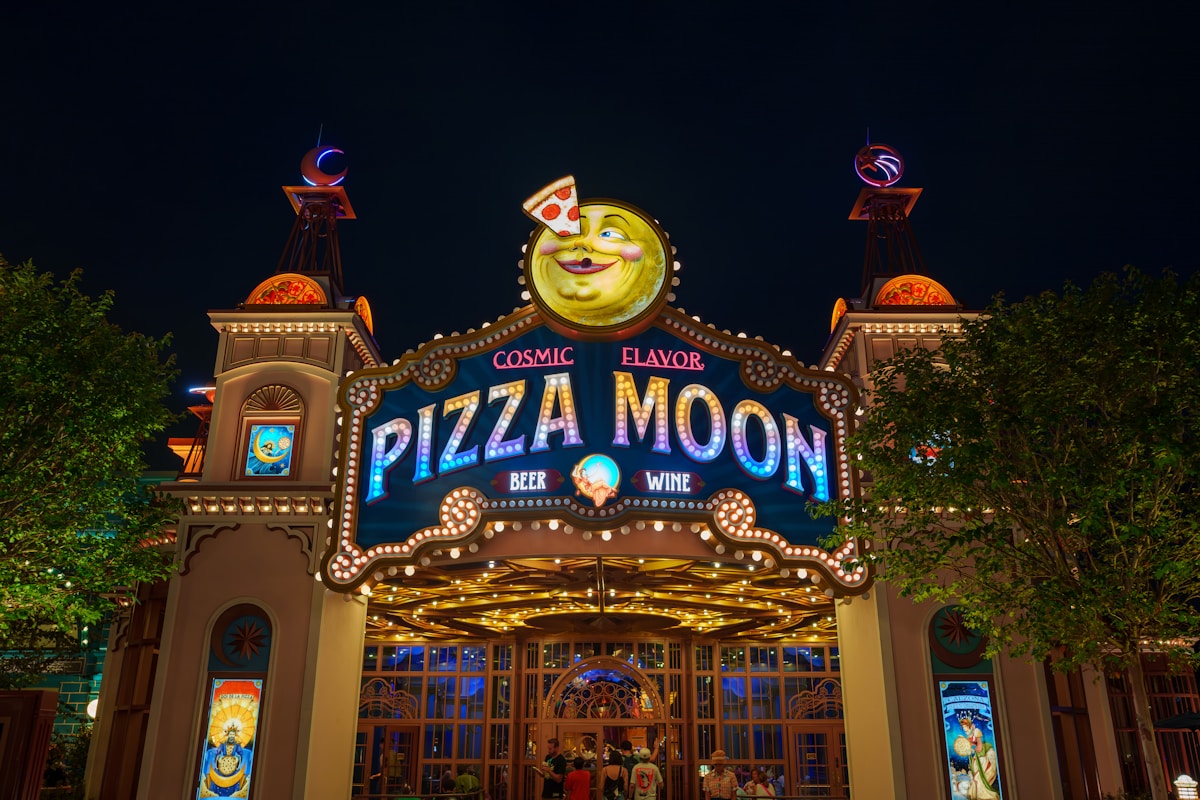 Pizza Moon restaurant entrance lit at night, Universal Epic Universe, Orlando