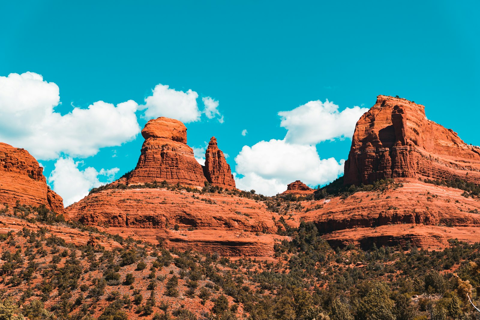 Red sandstone rock formations rising against a blue sky in Sedona, Arizona