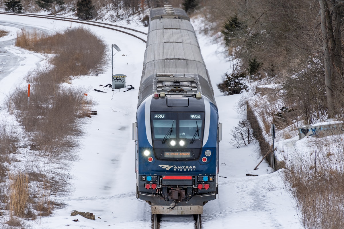 Amtrak Midwest train running through snowy countryside