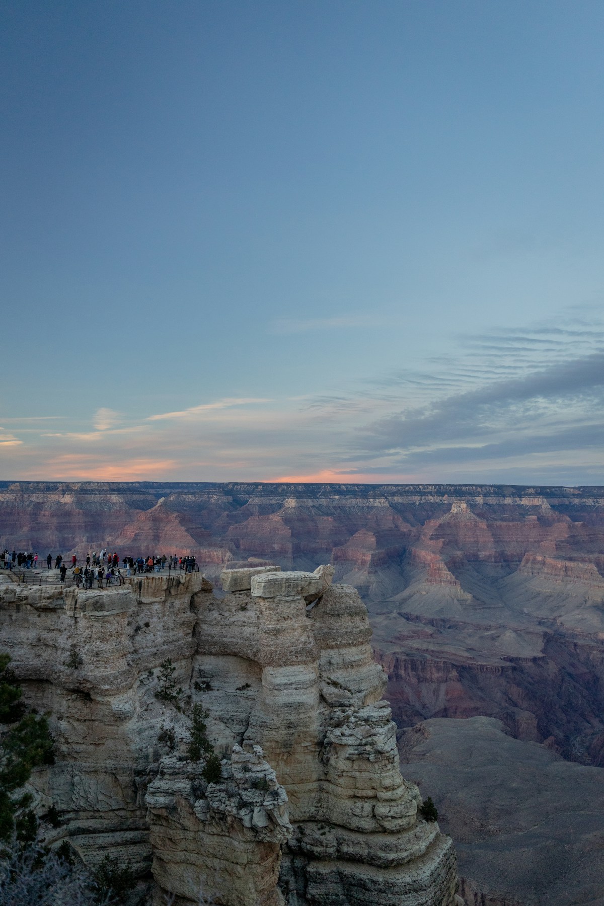 Morning light illuminating the layered rock walls of the Grand Canyon at sunrise
