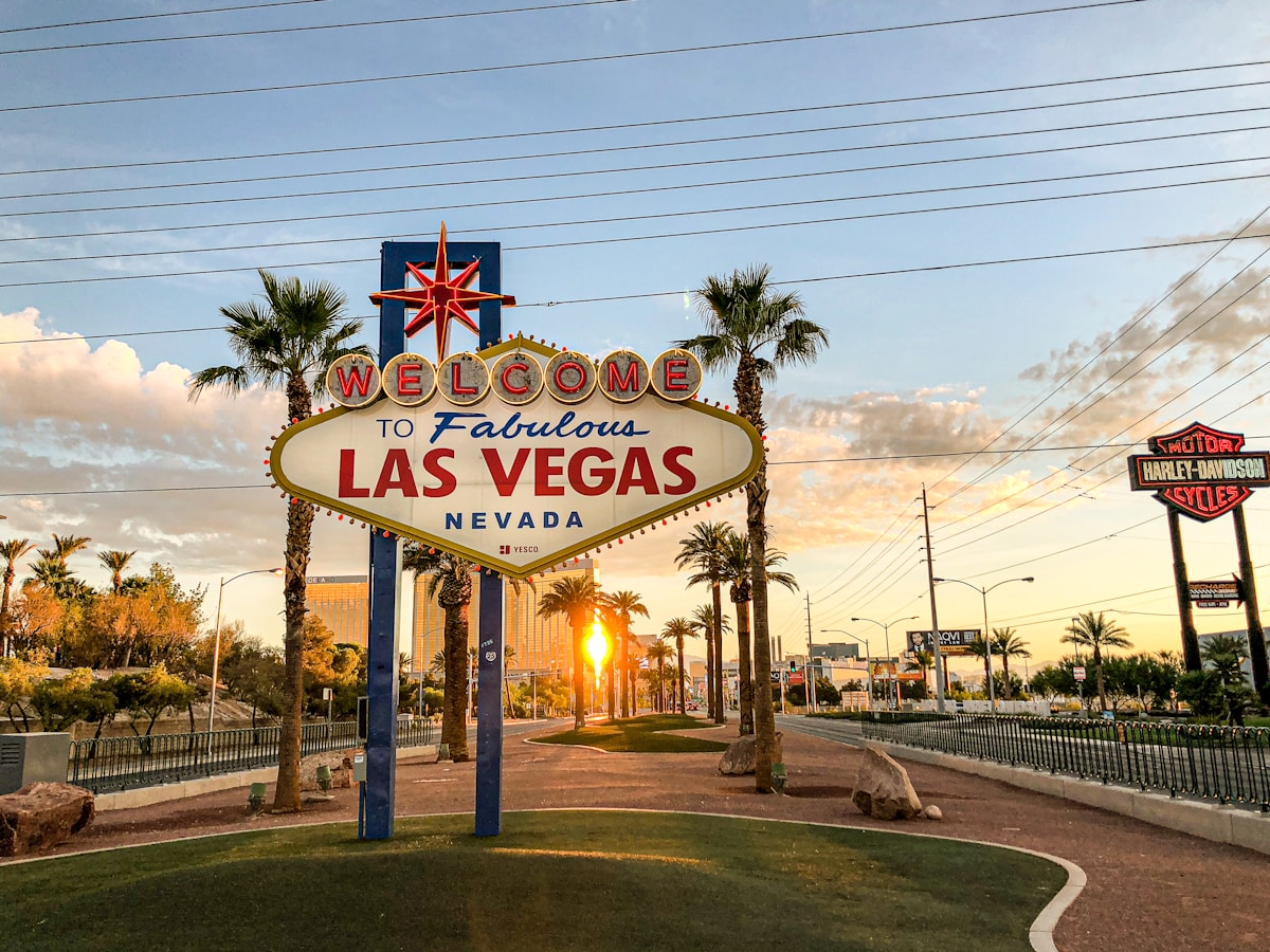 Welcome to Fabulous Las Vegas Nevada sign at sunset with palm trees
