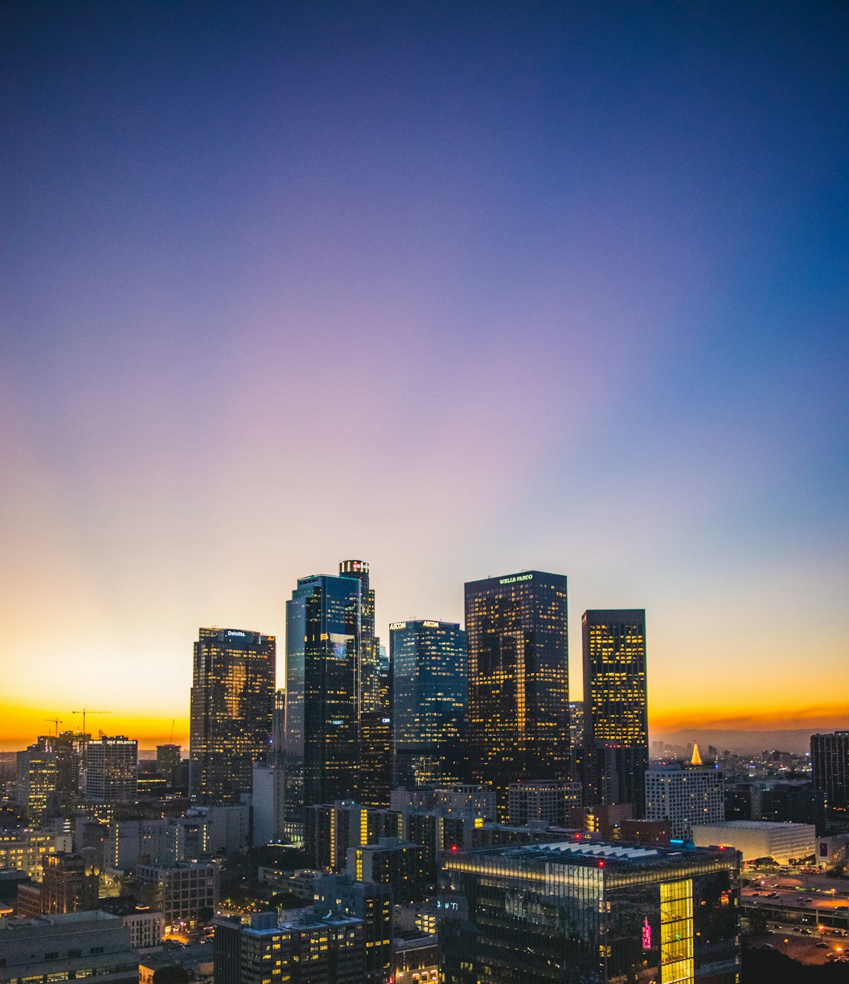 Downtown Los Angeles skyline lit up at sunset, California