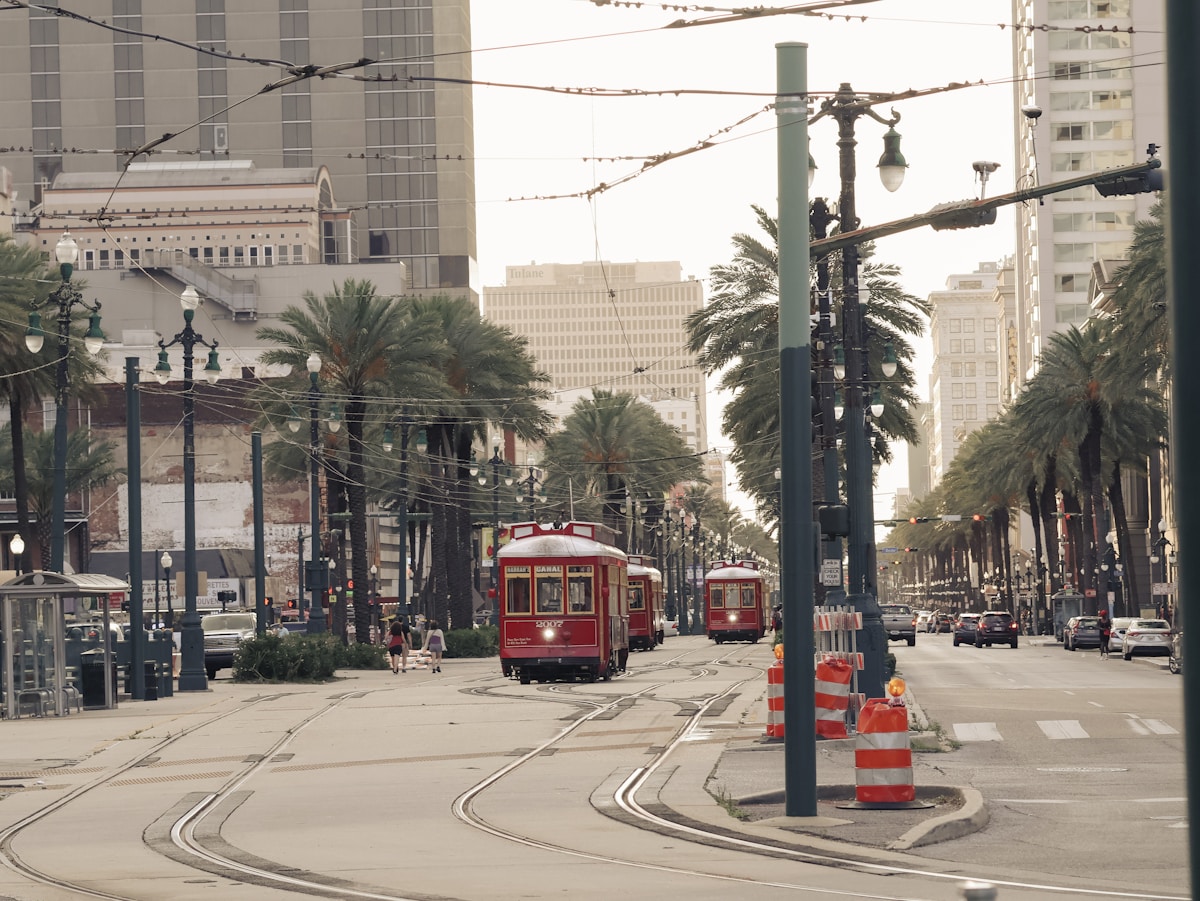 Red streetcar on a tree-lined street in the French Quarter, New Orleans