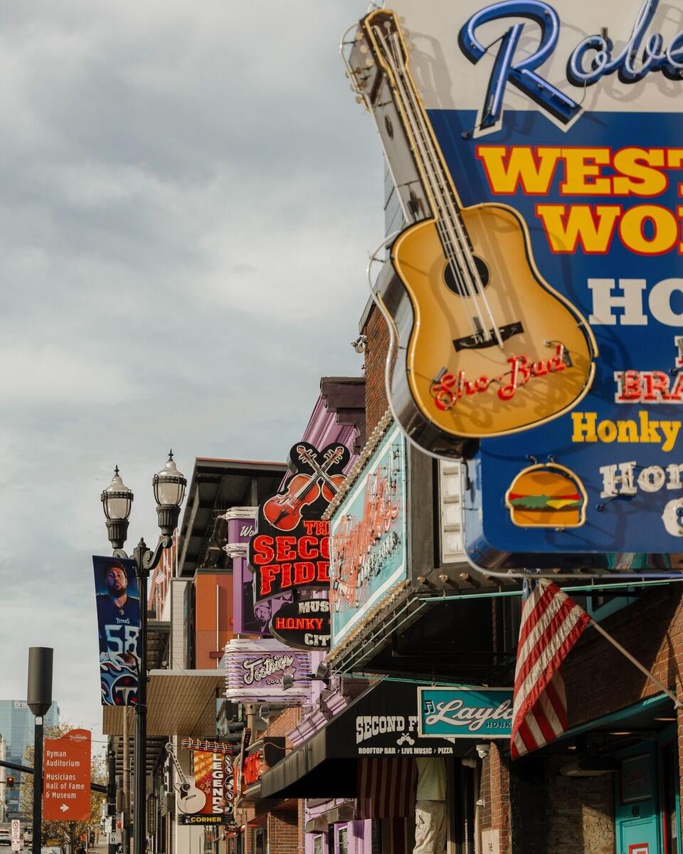 Lower Broadway in Nashville lit up with colorful neon honky-tonk signs at night, Tennessee