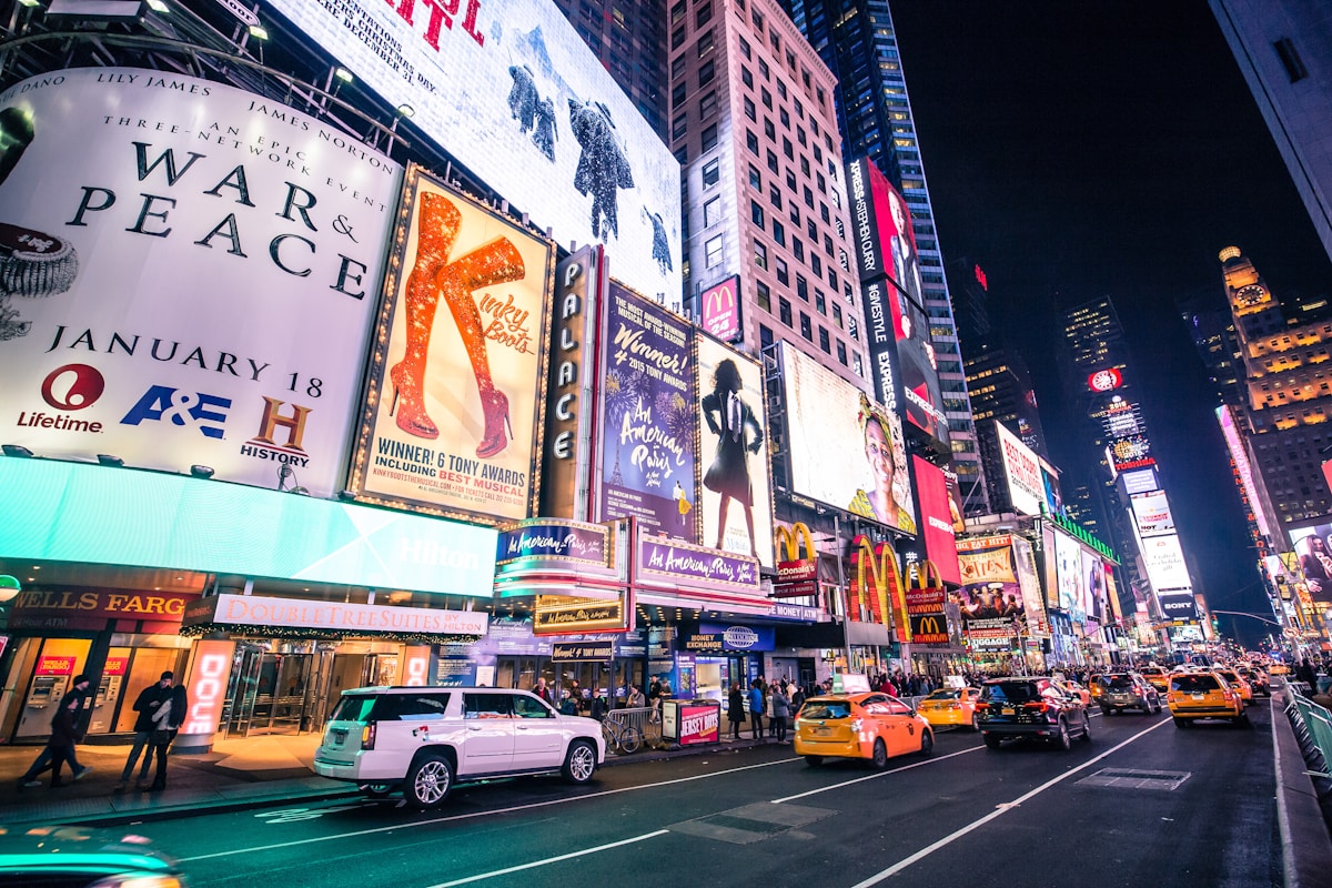 Times Square at night with neon billboards and yellow cabs, New York City