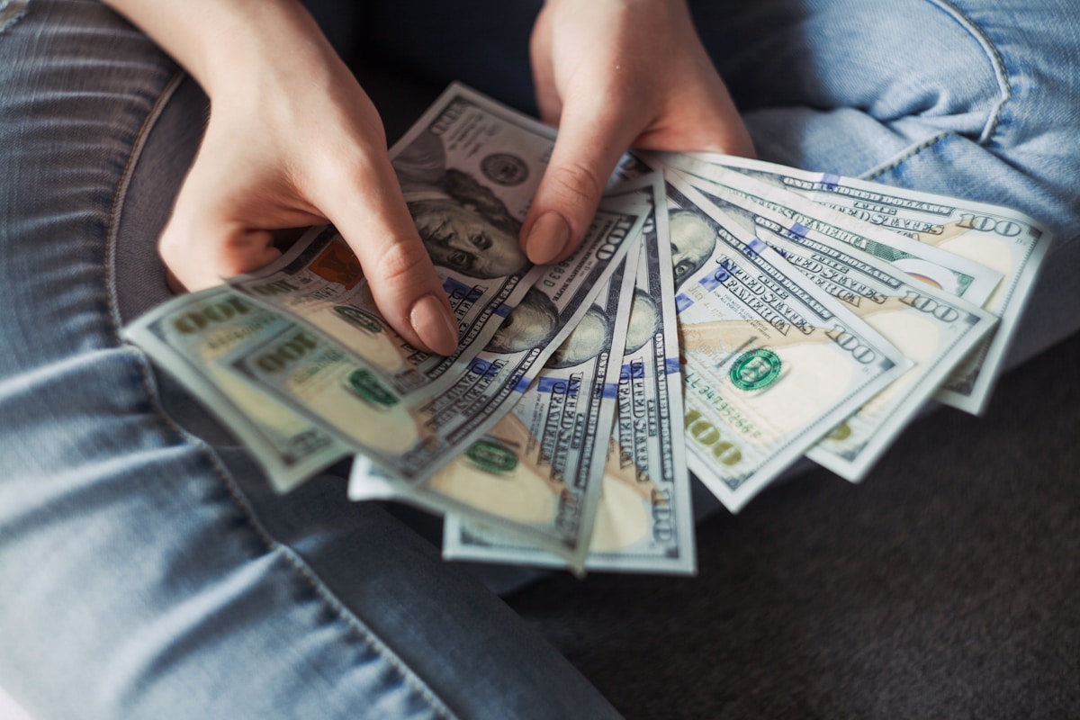 US dollar bills spread out on a table