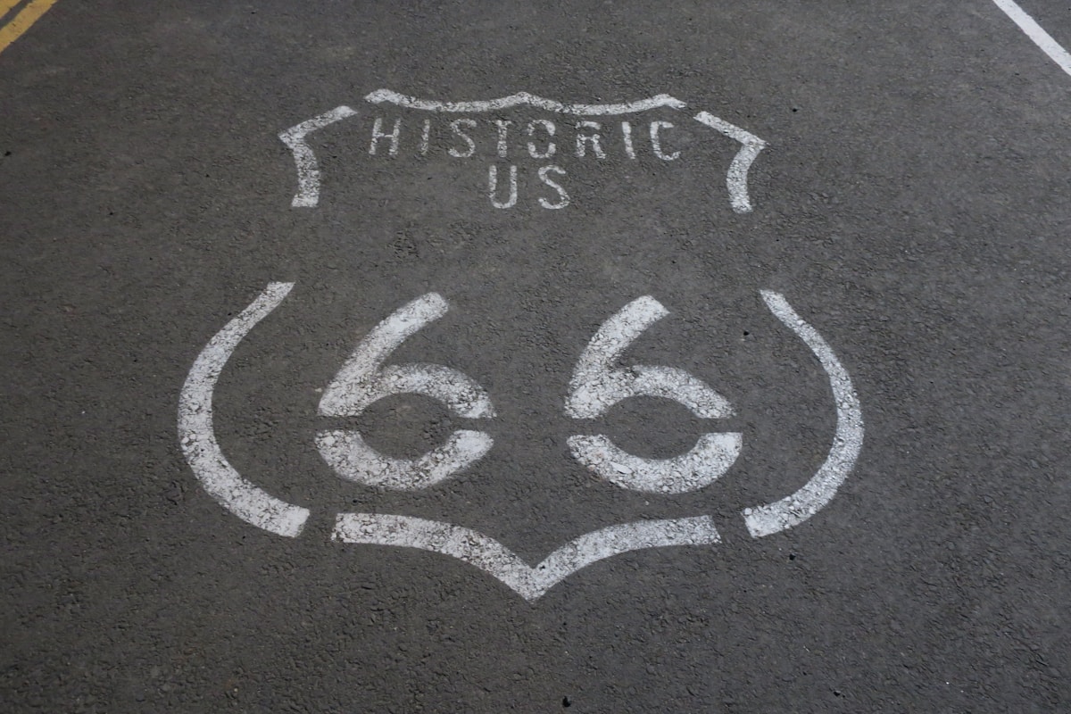 Historic Route 66 road sign beside a desert highway in California