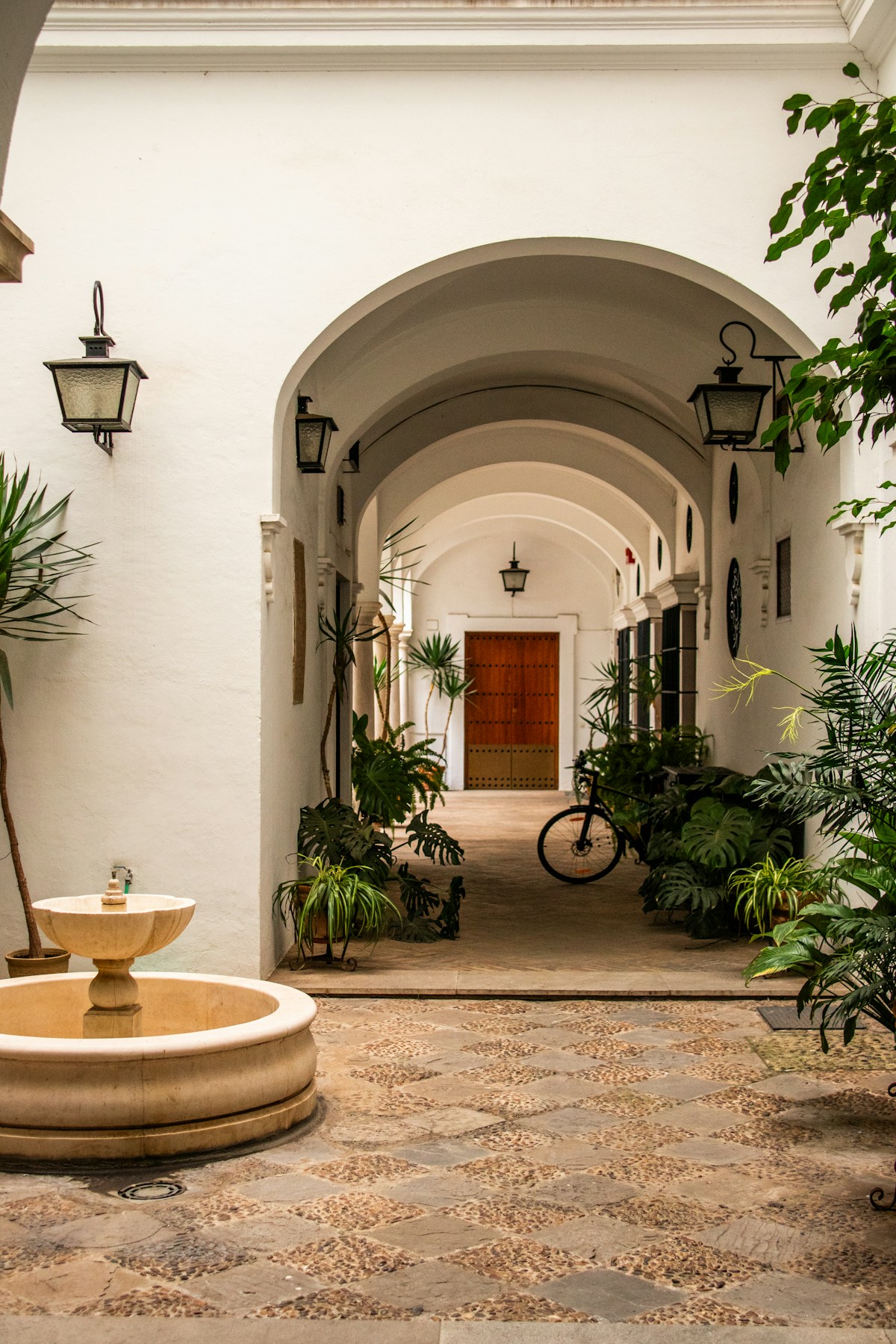 Adobe-style courtyard with fountain and terracotta pots — Santa Fe, New Mexico