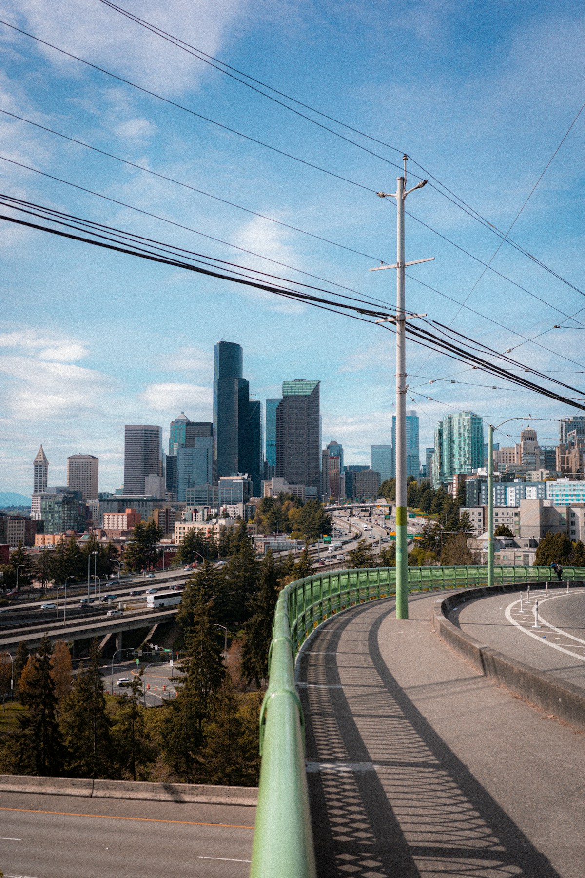 Seattle city skyline with highway and green railing, Washington