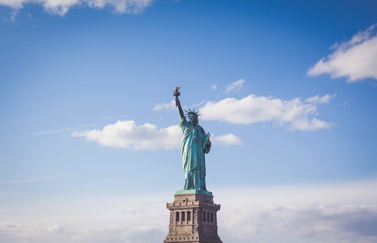 The Statue of Liberty on Liberty Island with New York Harbor in the background