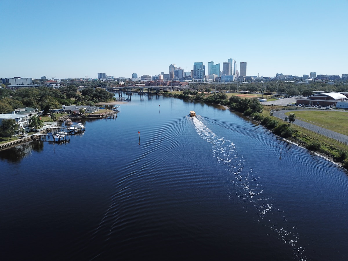 A white boat docked beside city buildings on the Tampa, Florida waterfront