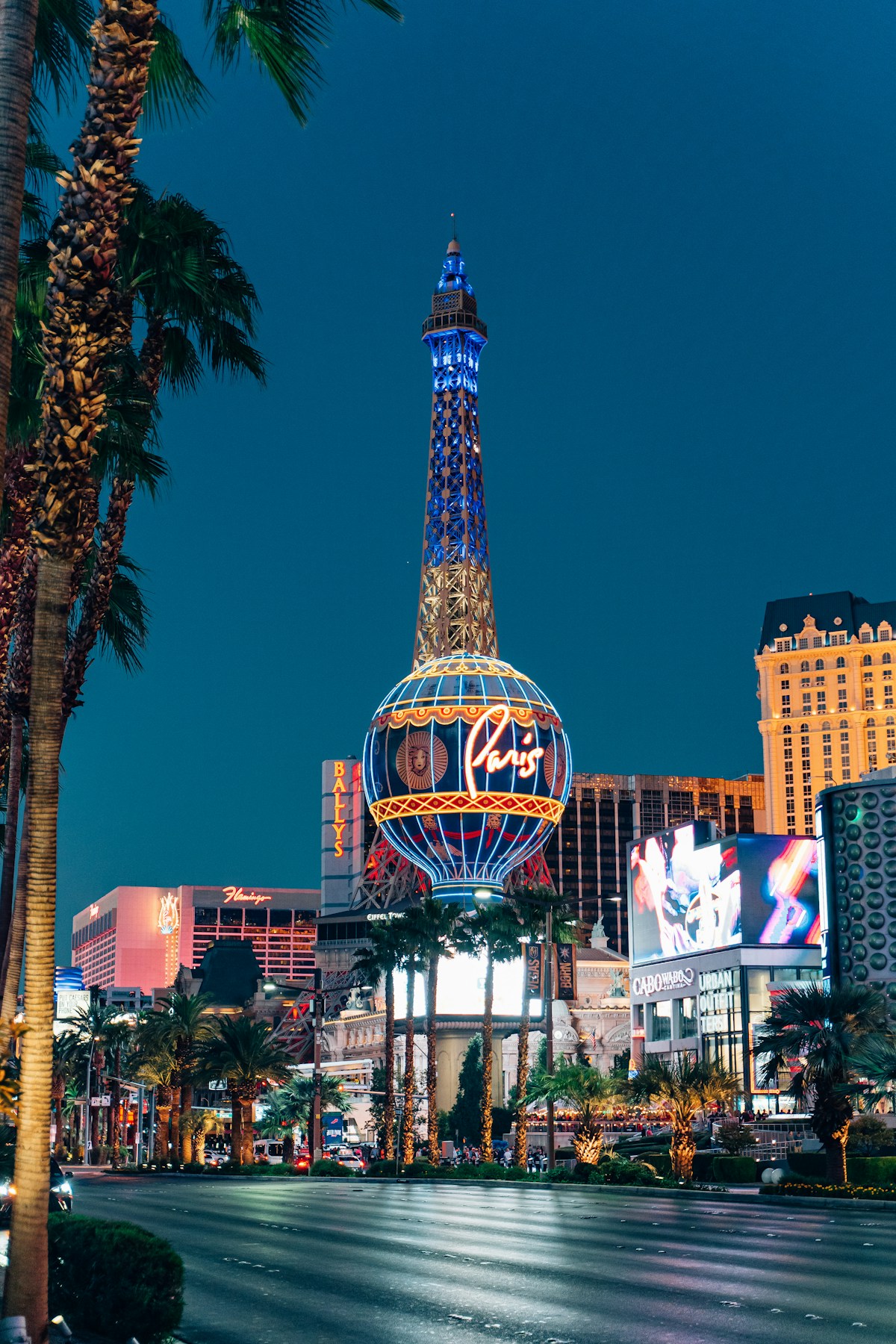 Paris Las Vegas Eiffel Tower replica lit up in neon at night on the Las Vegas Strip, Nevada
