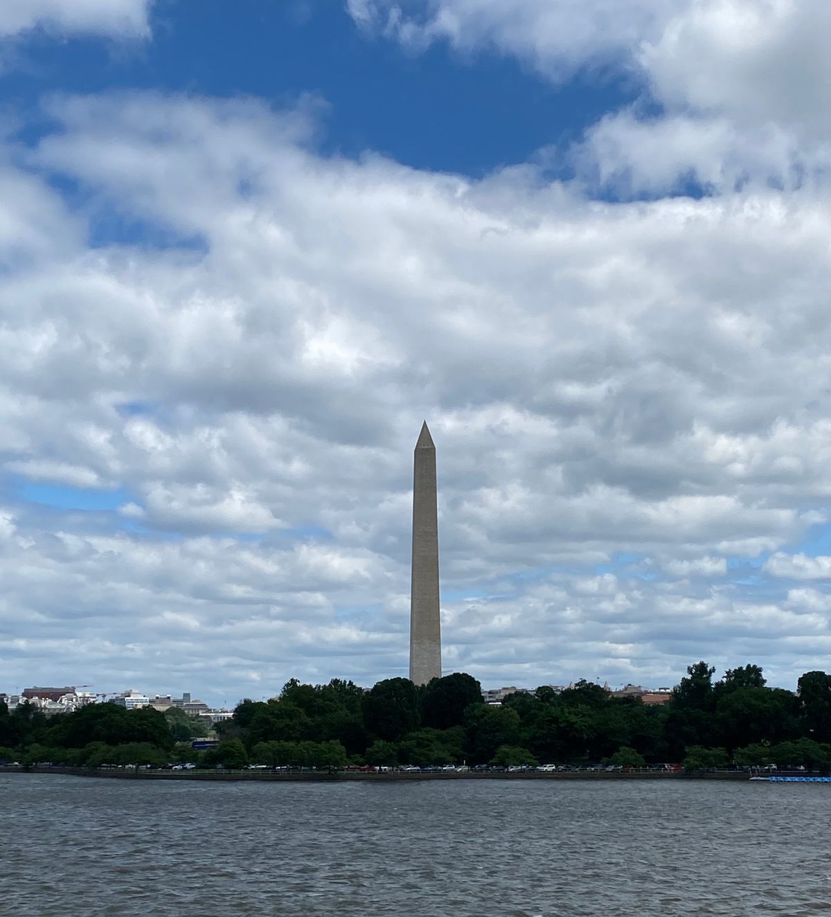 The Washington Monument seen across the Tidal Basin in Washington DC under a cloudy sky