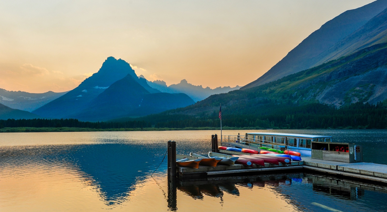 Boat at dock on the pristine waters of Glacier National Park, Montana